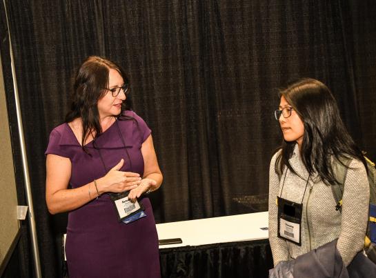2 women discussing at poster session