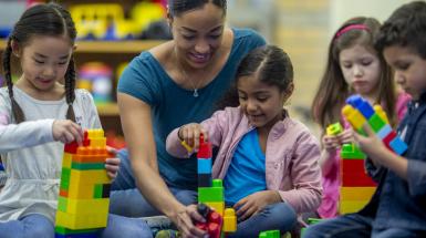 Woman and children using blocks