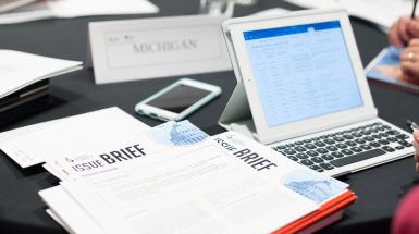Documents and a laptop on a desk